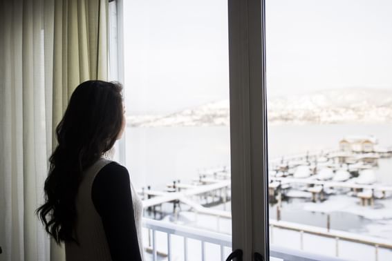 A woman looking out of the window at Manteo Resort