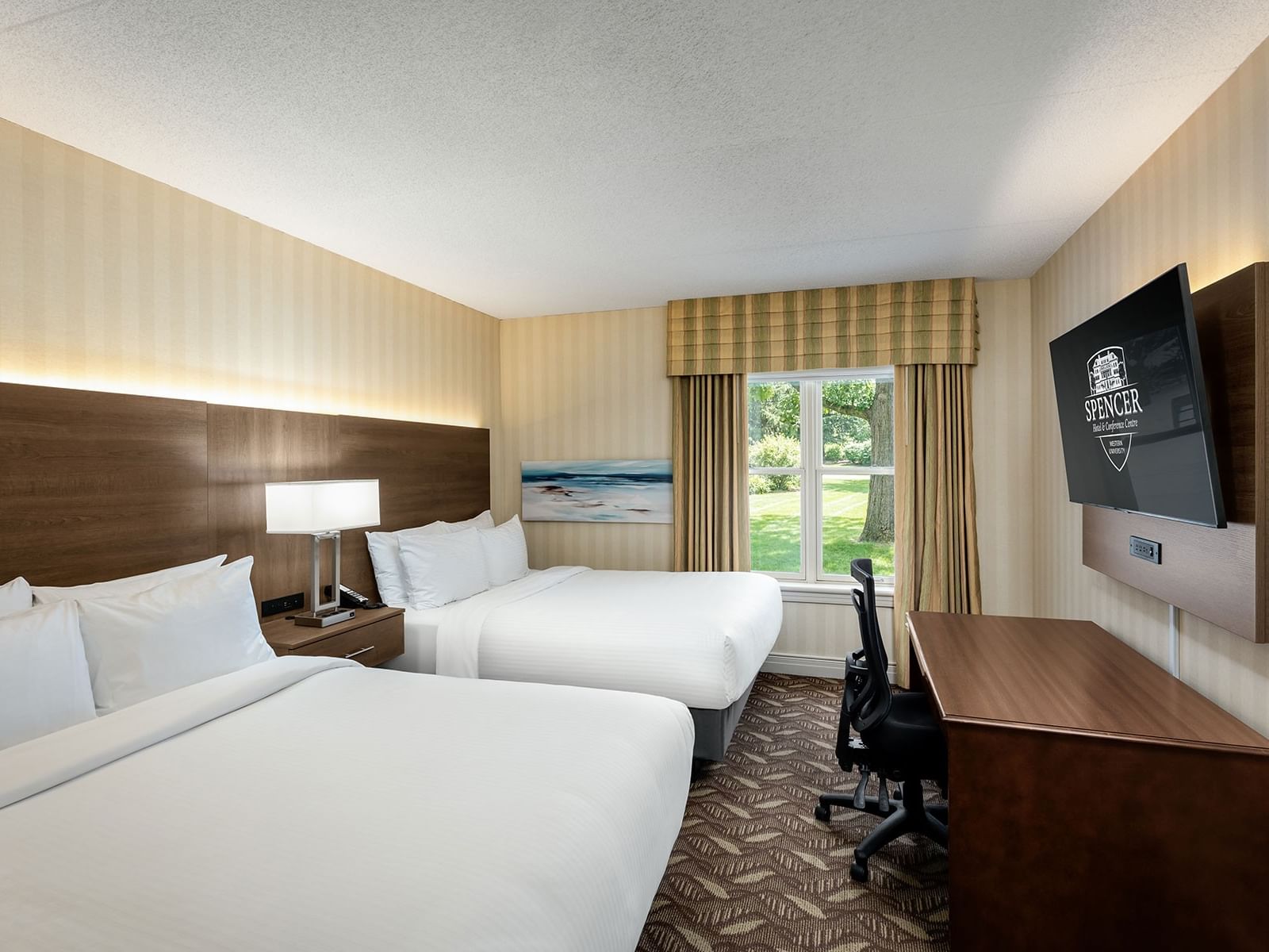 Work desk facing beds beside window in 2 Queen Bed Executive Wing Room at Spencer Hotel, best hotel rooms in London Ontario