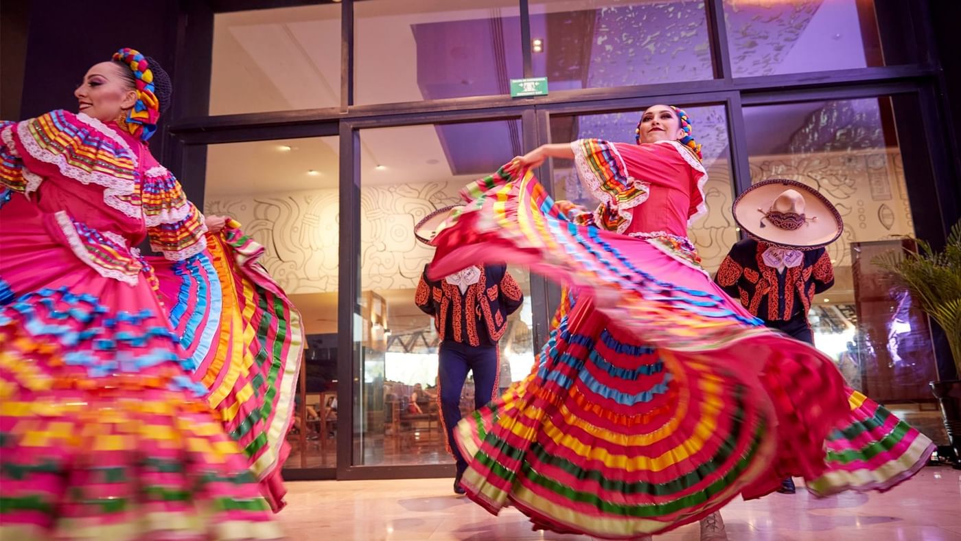 Dancers in colorful dresses performing at Fiesta Americana