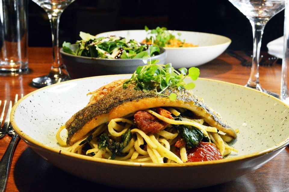 Pan-seared fish on linguine with a side salad at Gott's Bar & Kitchen, The Met Hotel Leeds, England