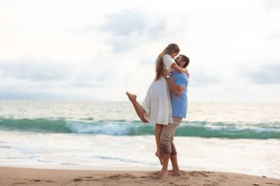 Couple embracing by the sea near Villa Premiere Boutique Hotel & Romantic Getaway