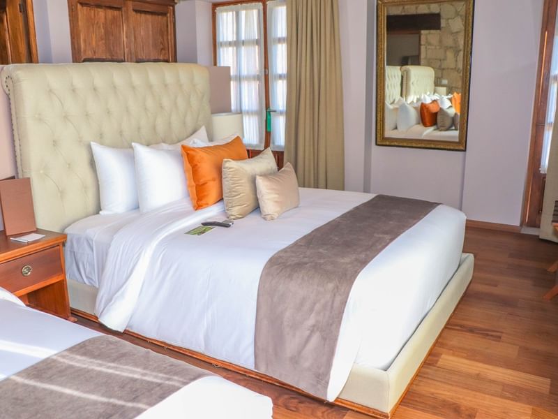 Twin beds with wooden floor in Junior Suite at Gamma Hotels