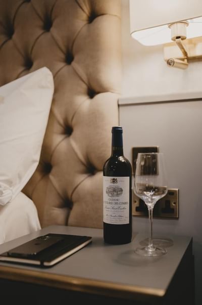 wine on the side of bed at easthampstead park in wokingham