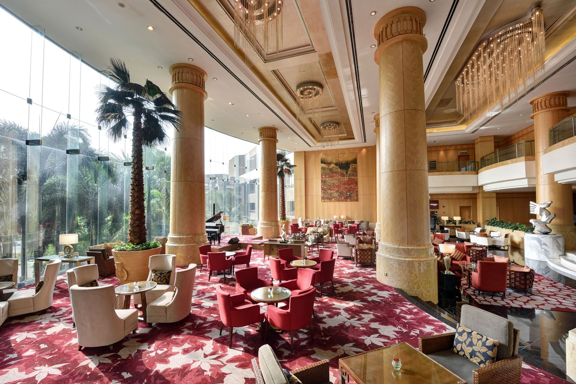 Sphere Lounge featuring white & red themed interior with large chandeliers at One World Hotel