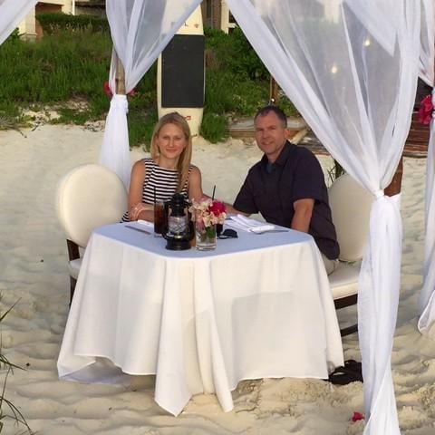 Couple seated in a hut on the beach, The Somerset on Grace Bay
