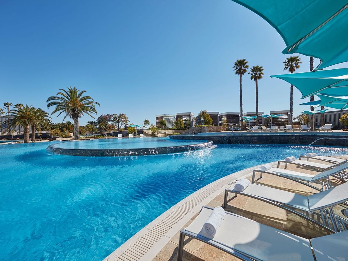 Close-up on the sun beds by the outdoor pool at Crown Hotels