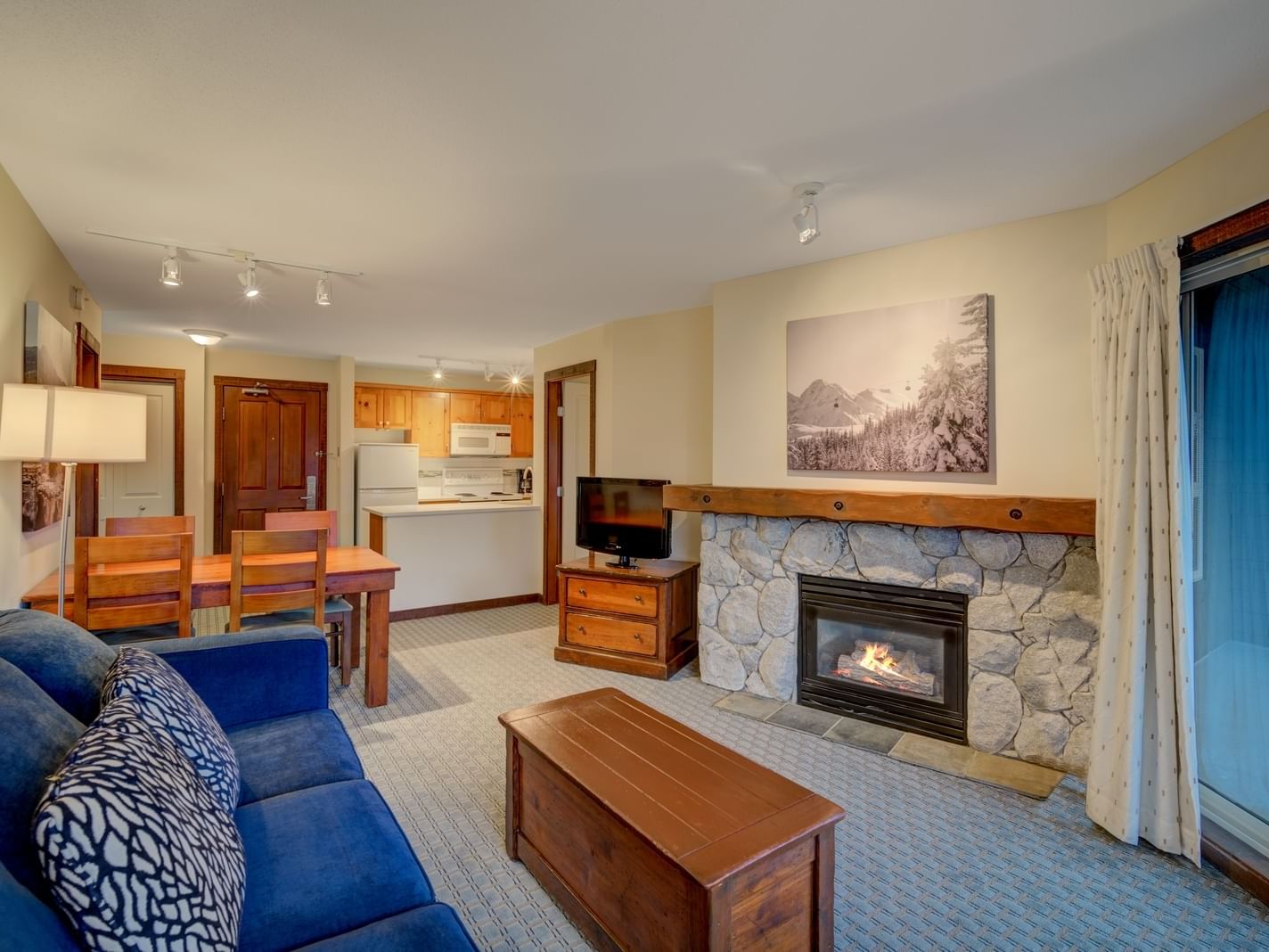 living room with blue couch and fireplace