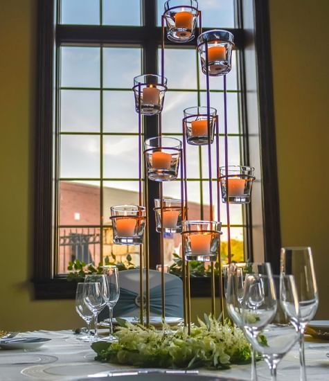 Tall candle holder with lit candles on a table at The Wildwood Hotel