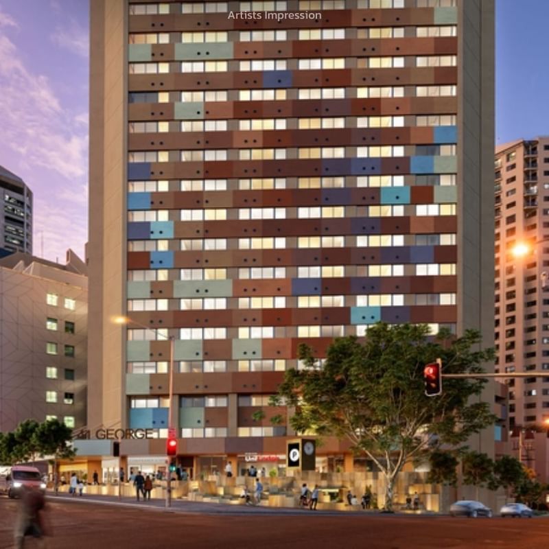 Modern multi-story building with colorful facade situated in a busy city street.