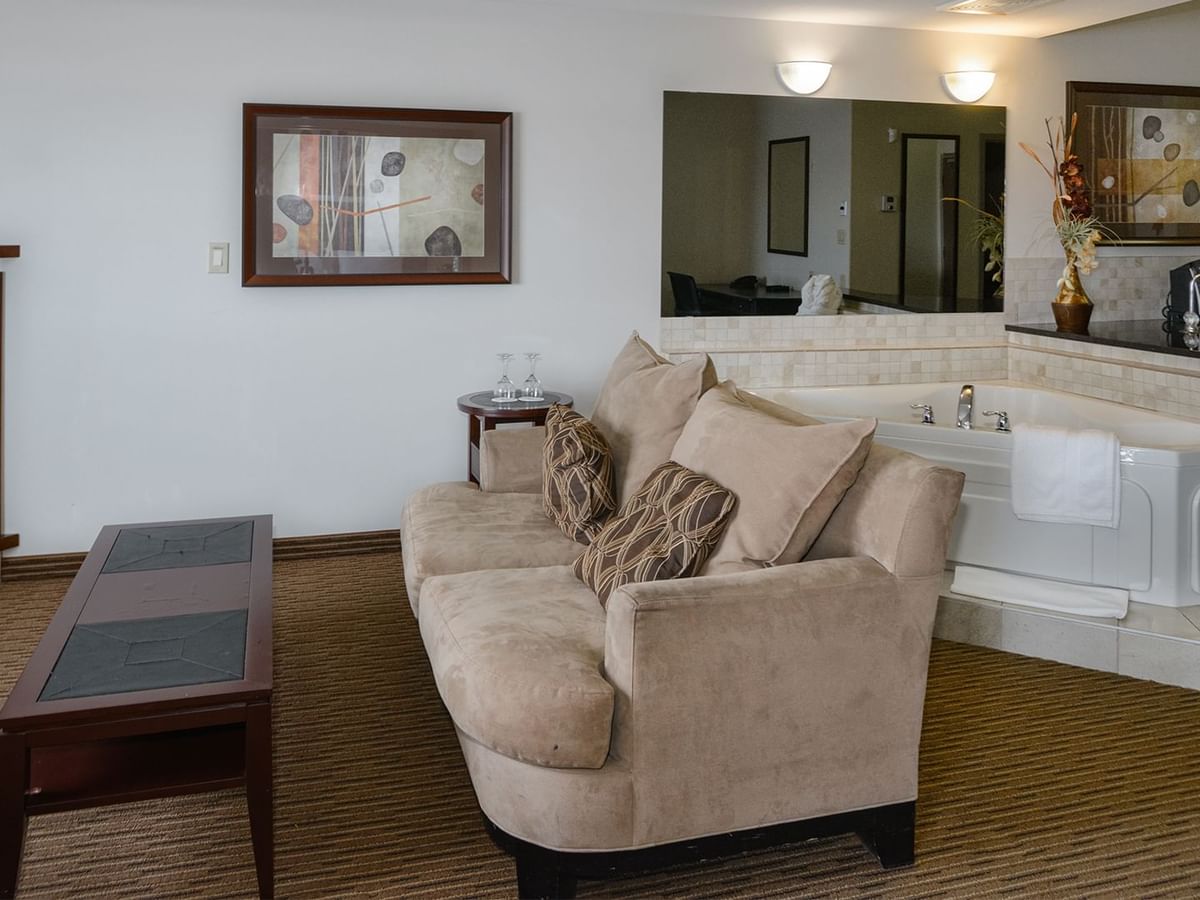 Hotel suite with a separate living room, equipped with a jetted tub