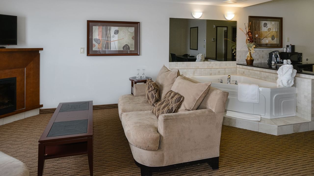 Hotel suite with a separate living room, equipped with a jetted tub