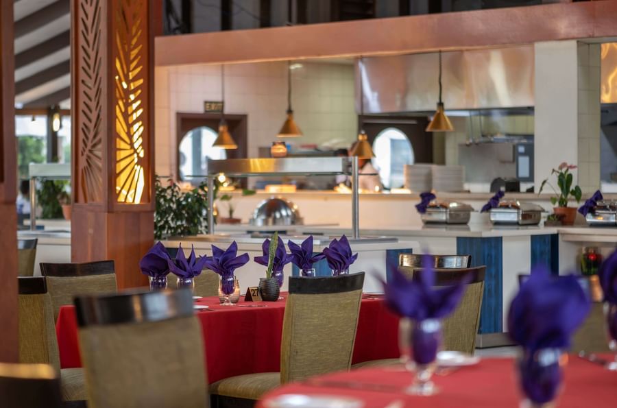 Elegant dining area with purple napkins and red tablecloths at Tokatoka Resort - Fiji International Airport.