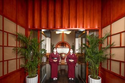 Two waitresses by the entrance at Hanoi Daewoo Hotel