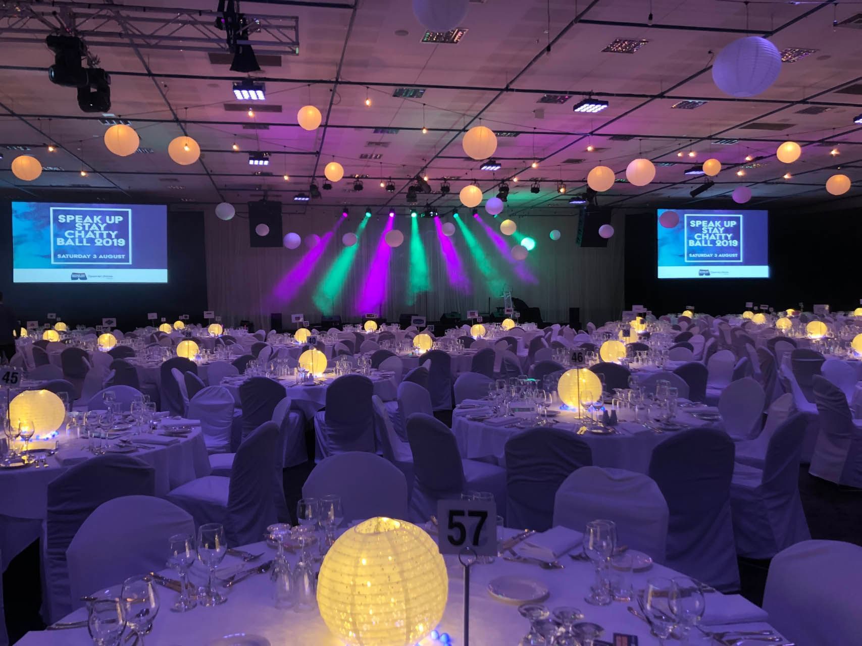 Banquet tables set-up in Federation Ballroom with purple lighting at Grand Chancellor Hobart