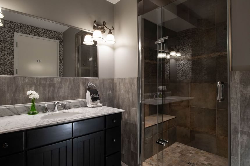 Shower area & bathroom vanity with mirror in King Superior at Retro Suites Hotel