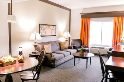 living room in hotel with window and orange curtains