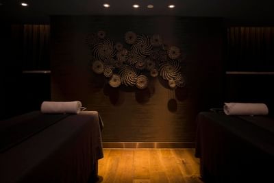 A Dark themed portrait of spa beds in a spa at White Swan hotel