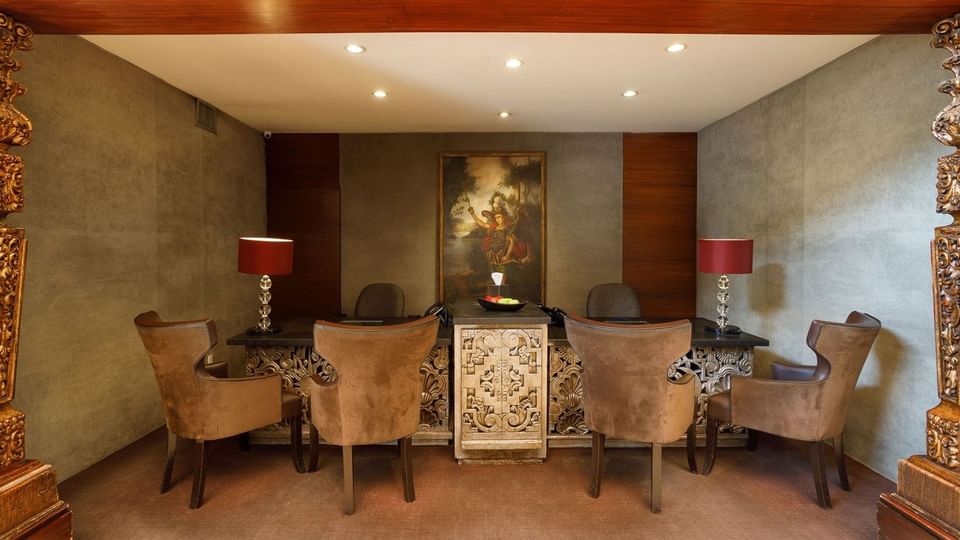 Elegant lobby featuring ornate wood carvings and classical artwork at Quinta Real Guadalajara