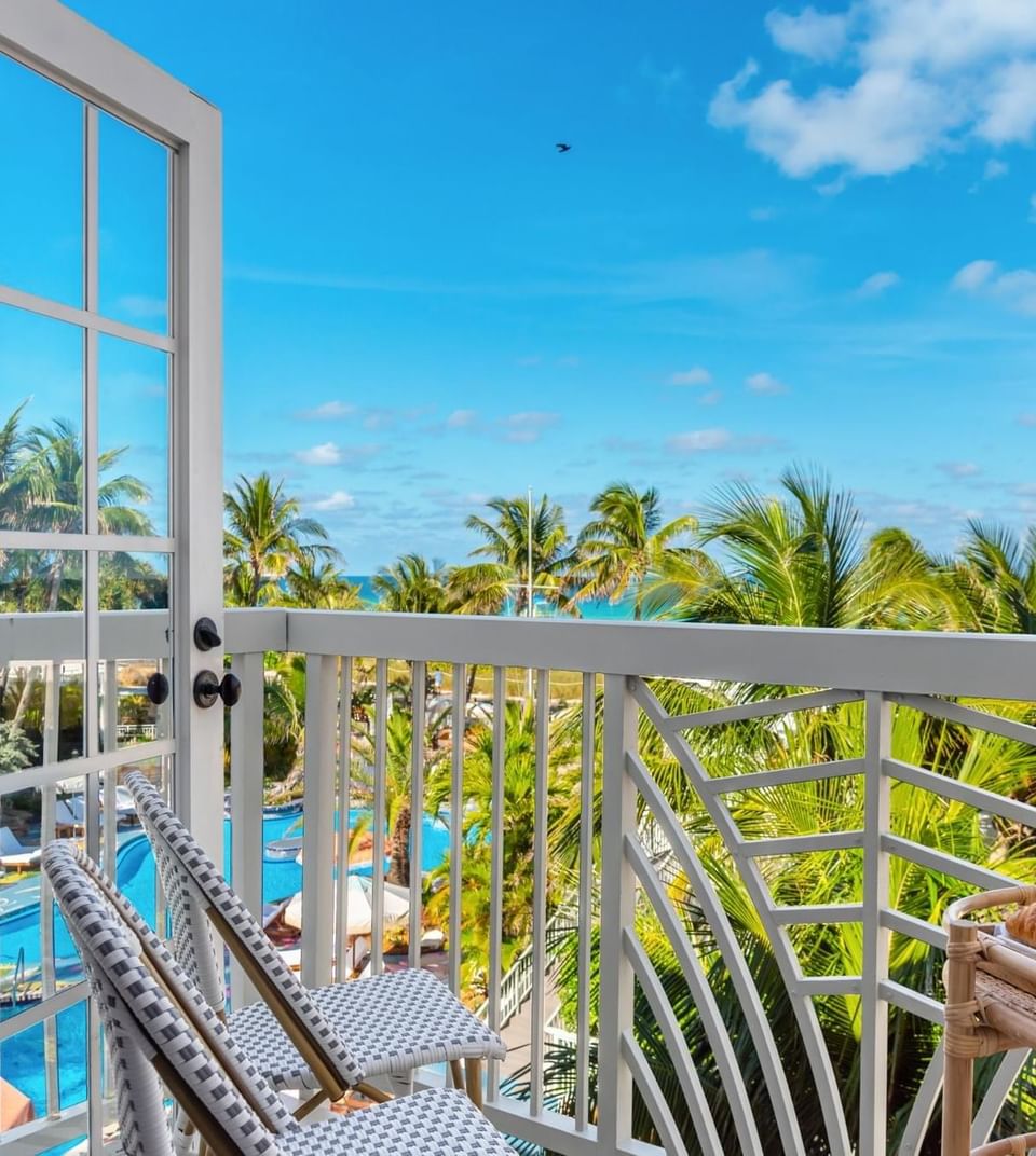 Balcony overlooking the ocean with palm trees in a Suite with Balcony at The Savoy On South Beach