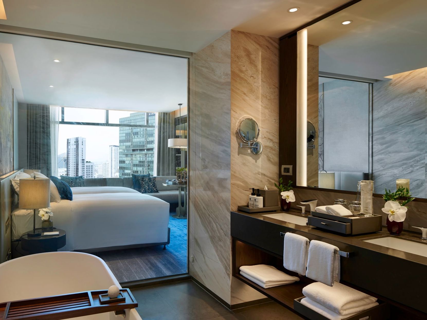 Bathroom & bedroom in Deluxe Room at Chatrium Grand Bangkok