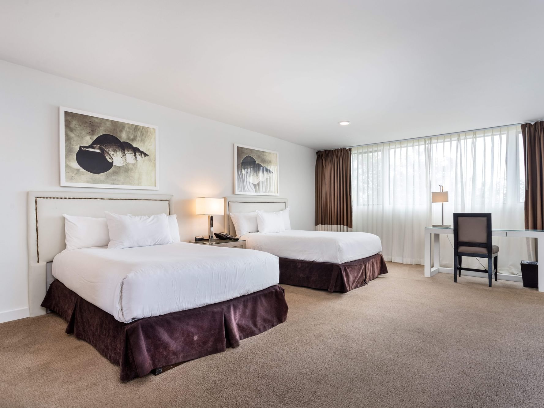 Double bed and work area in Superior Two Double at Luxe Sunset Boulevard Hotel