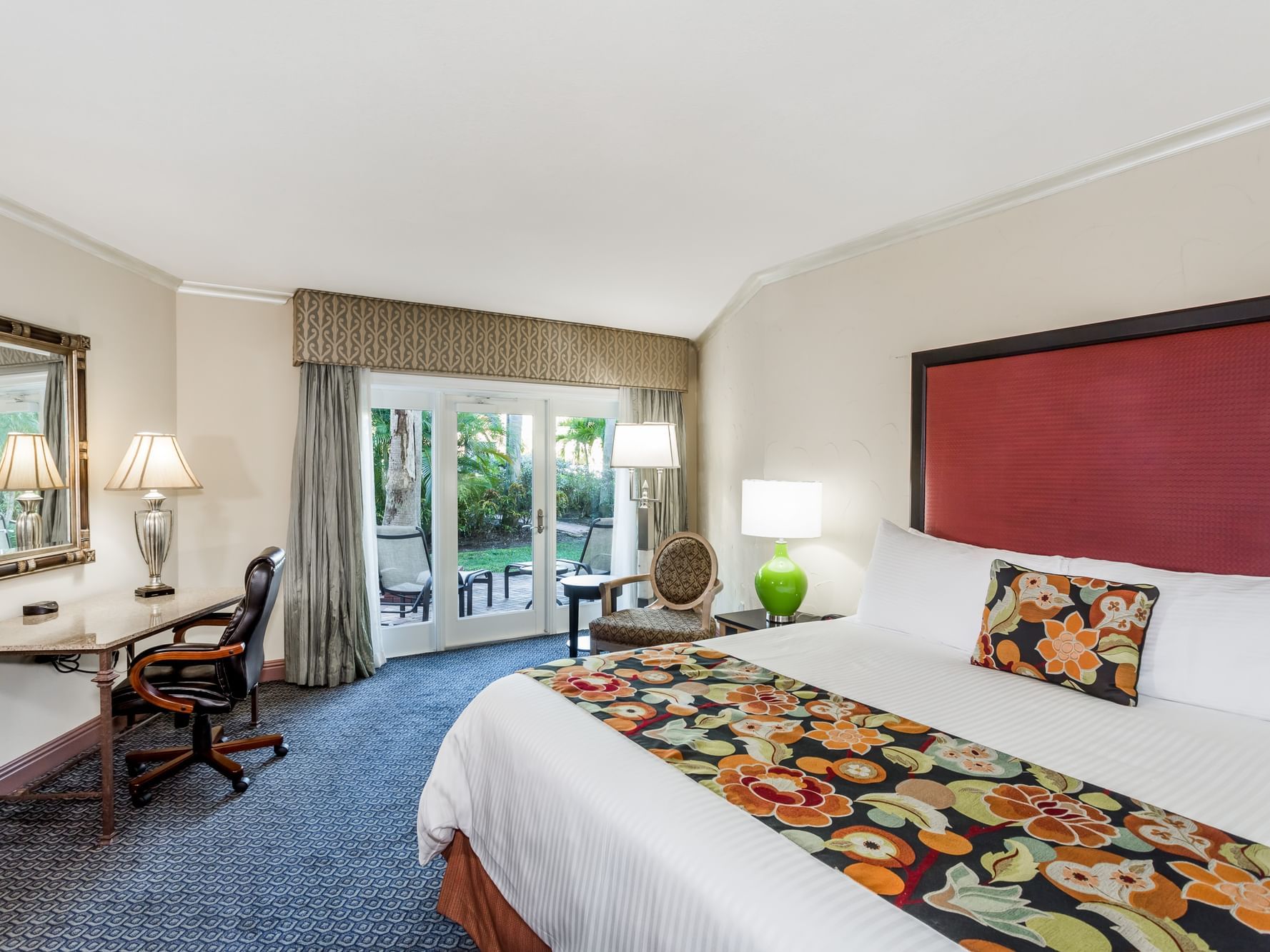 One King Deluxe Bedroom with a large bed and outdoor patio or balcony, at Safety Harbor hotel.