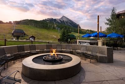 Outdoor seating with fire pit and mountain view at Elevation Resort Spa