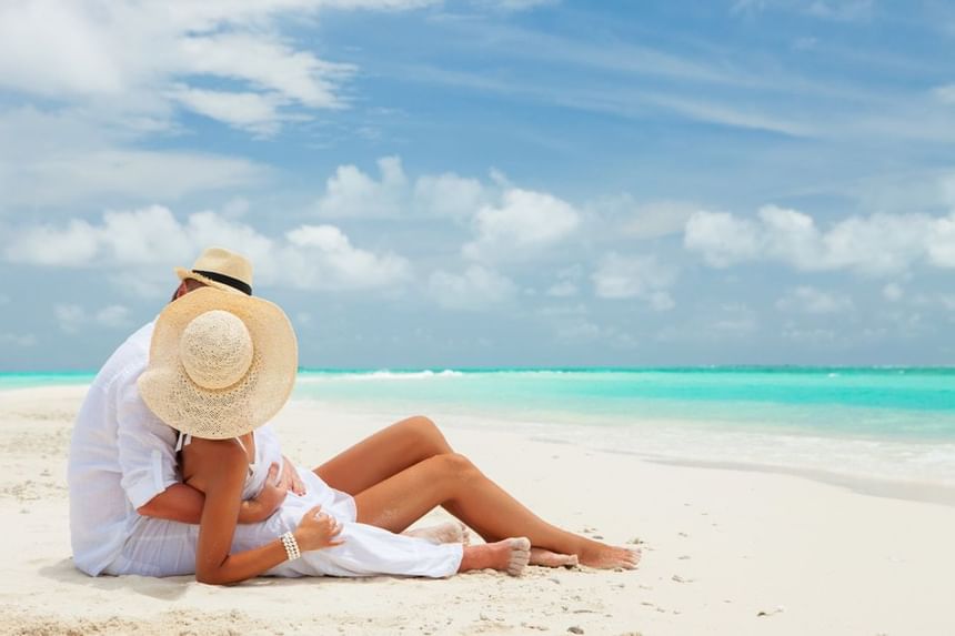 Couple posing by the beach at The Abidah Hotel, capturing the romance of a quiet adults-only resort in Barbados for honeymoon