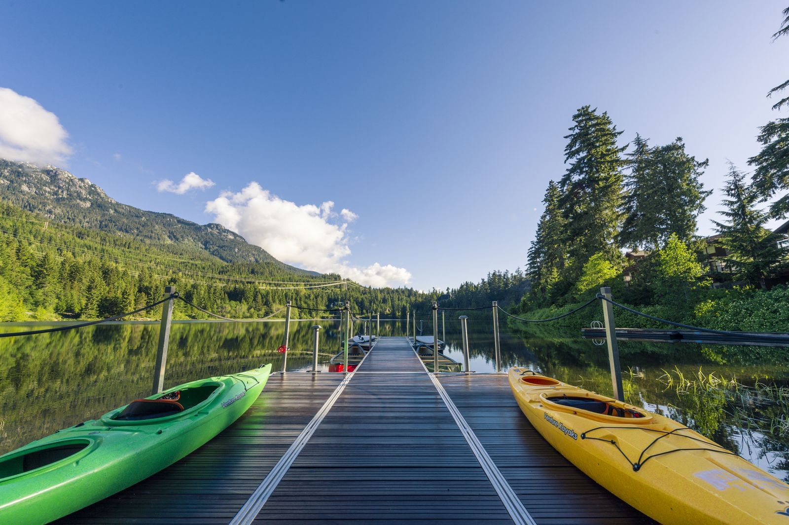 Kayaks on a dock by the lake at Nita Lake Lodge
