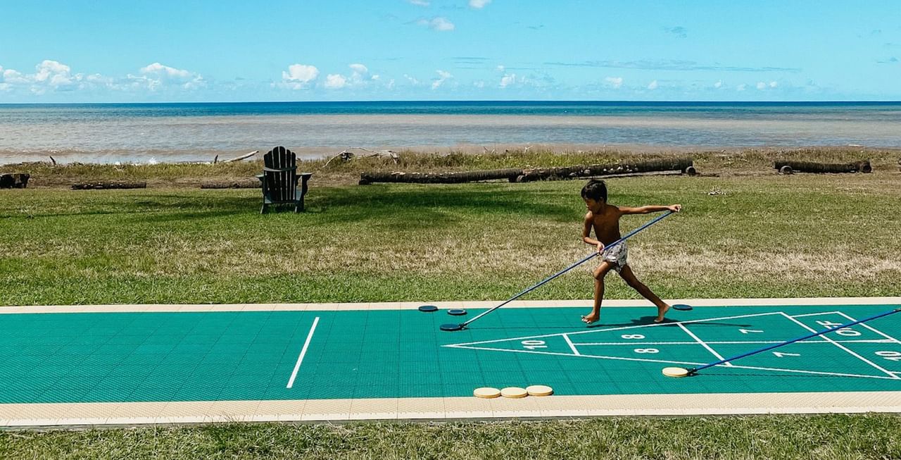 Kid playing shuffle board