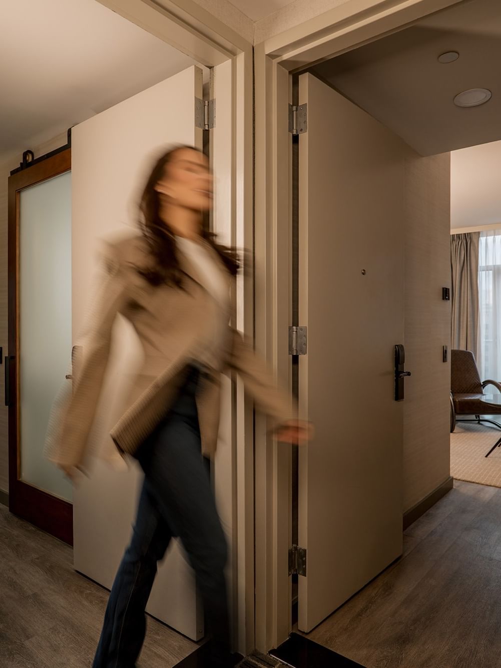 Guest walking through hallway of Two-Bedroom Gansevoort Suite at Gansevoort Meatpacking NYC - NEW in New York.