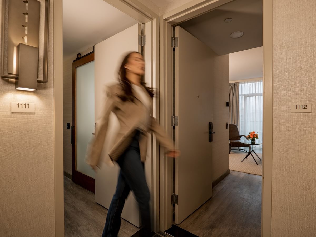 Guest walking through hallway of Two-Bedroom Gansevoort Suite at Gansevoort Meatpacking NYC - NEW in New York.