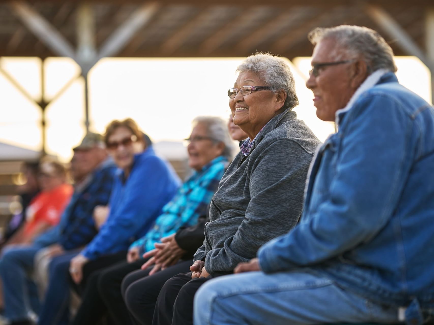 Elderly people sitting & enjoying outdoors featuring Senior Rate at Franklin Suite Hotel