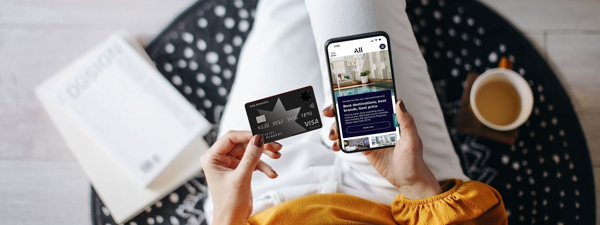 Top view of lady making payments on her phone featuring, Accor partners with NAB at Pullman Sydney Olympic Park