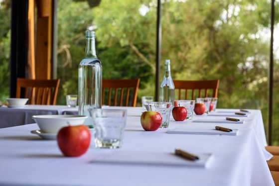 Apples and glasses in a meeting room table at Strahan Village 
