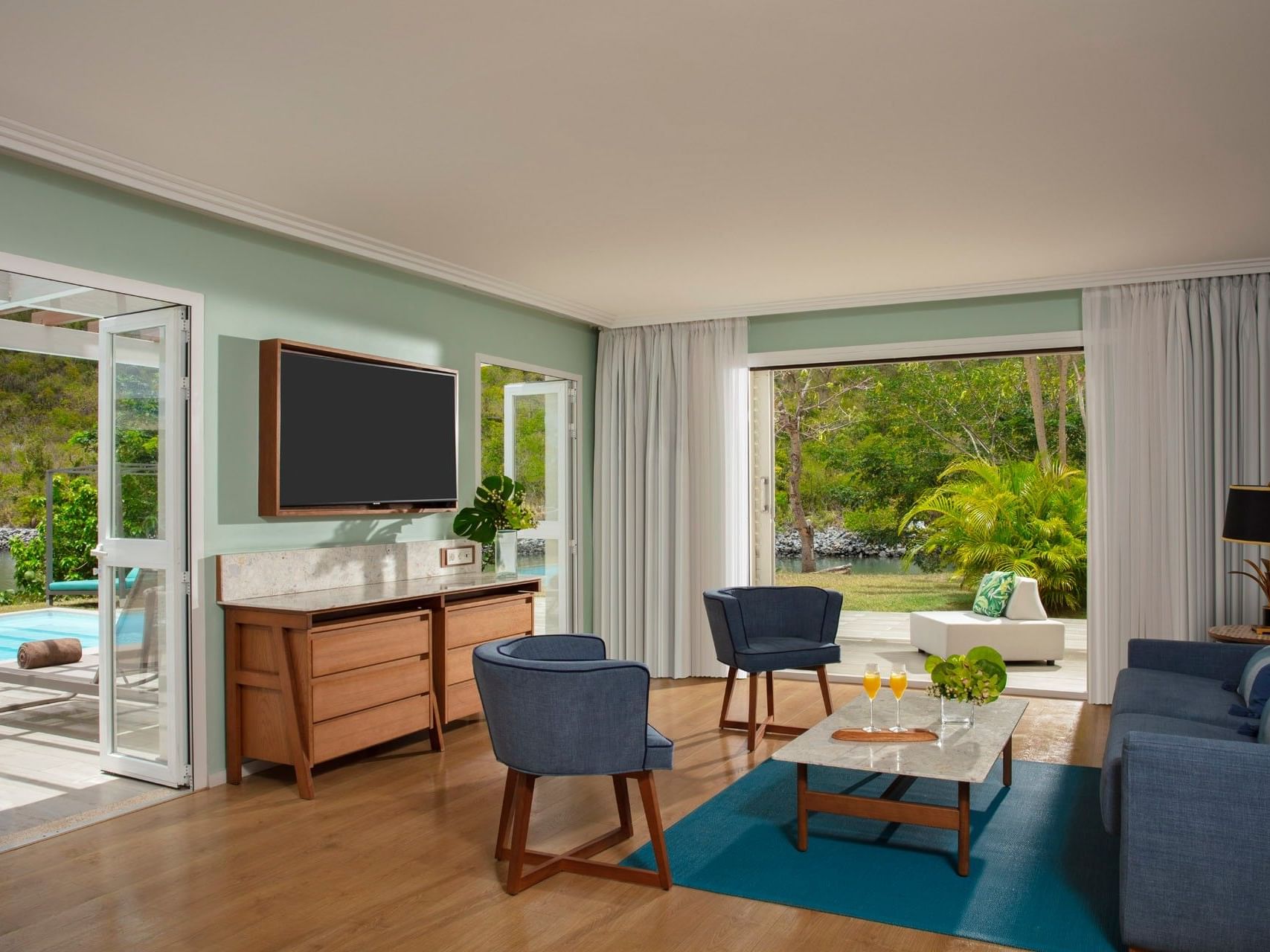 Living area with TV and plush seating in St. Martin Presidential 2 Bedroom Suite at Saint Martin Beach Resort & Spa