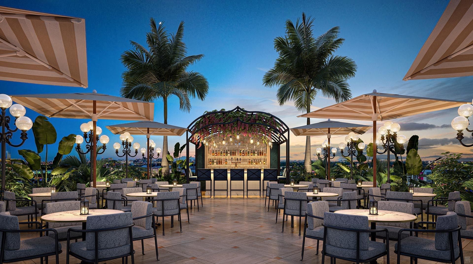 Outdoor bar area with umbrellas, palm trees, and tables with lights at The 27 Wynwood