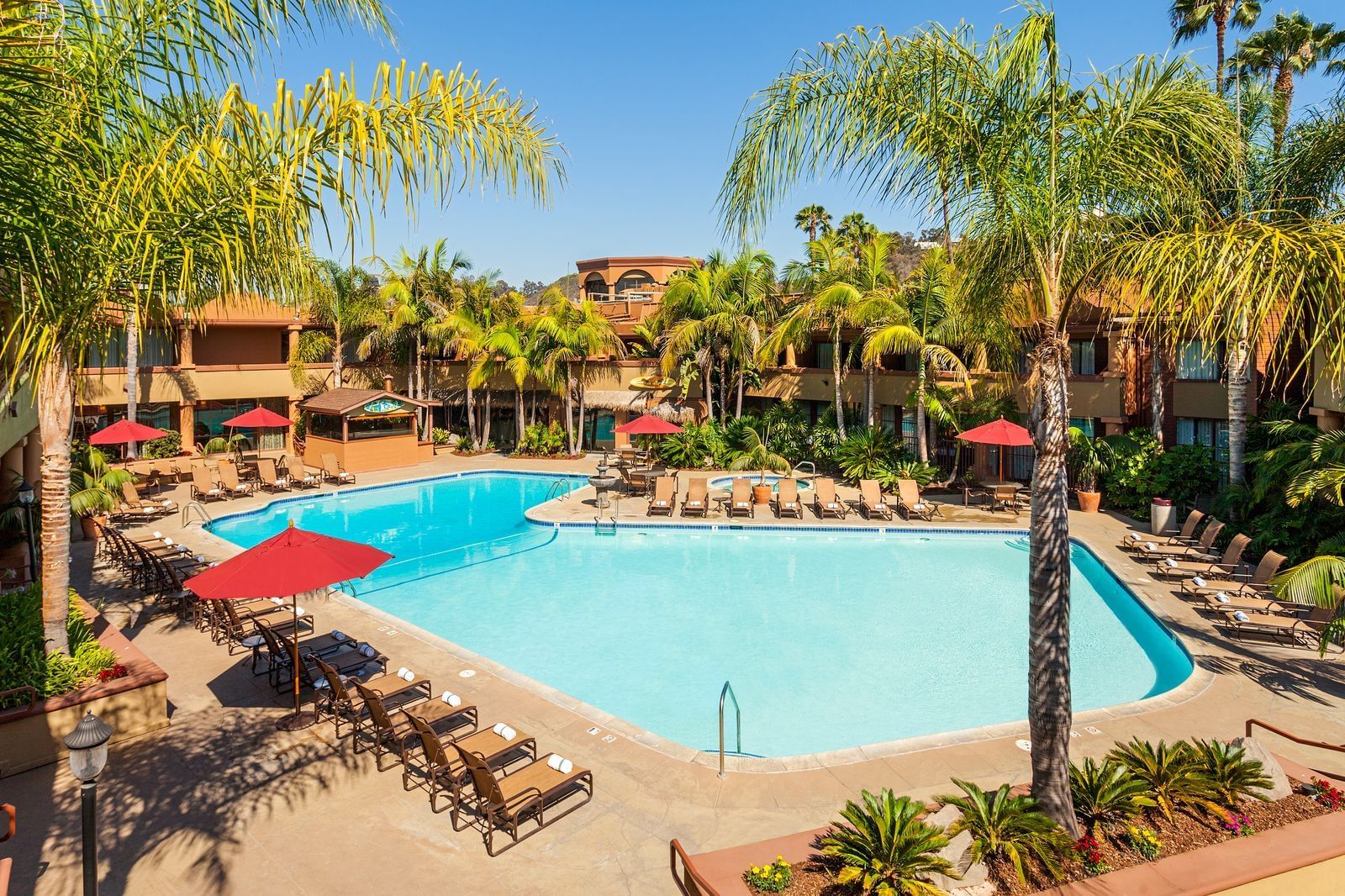 View of the outdoor pool with a sunbed area at Handlery Hotel