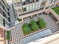 Aerial view of ReStays Ottawa courtyard featuring a checkerboard pattern, and lush greenery
