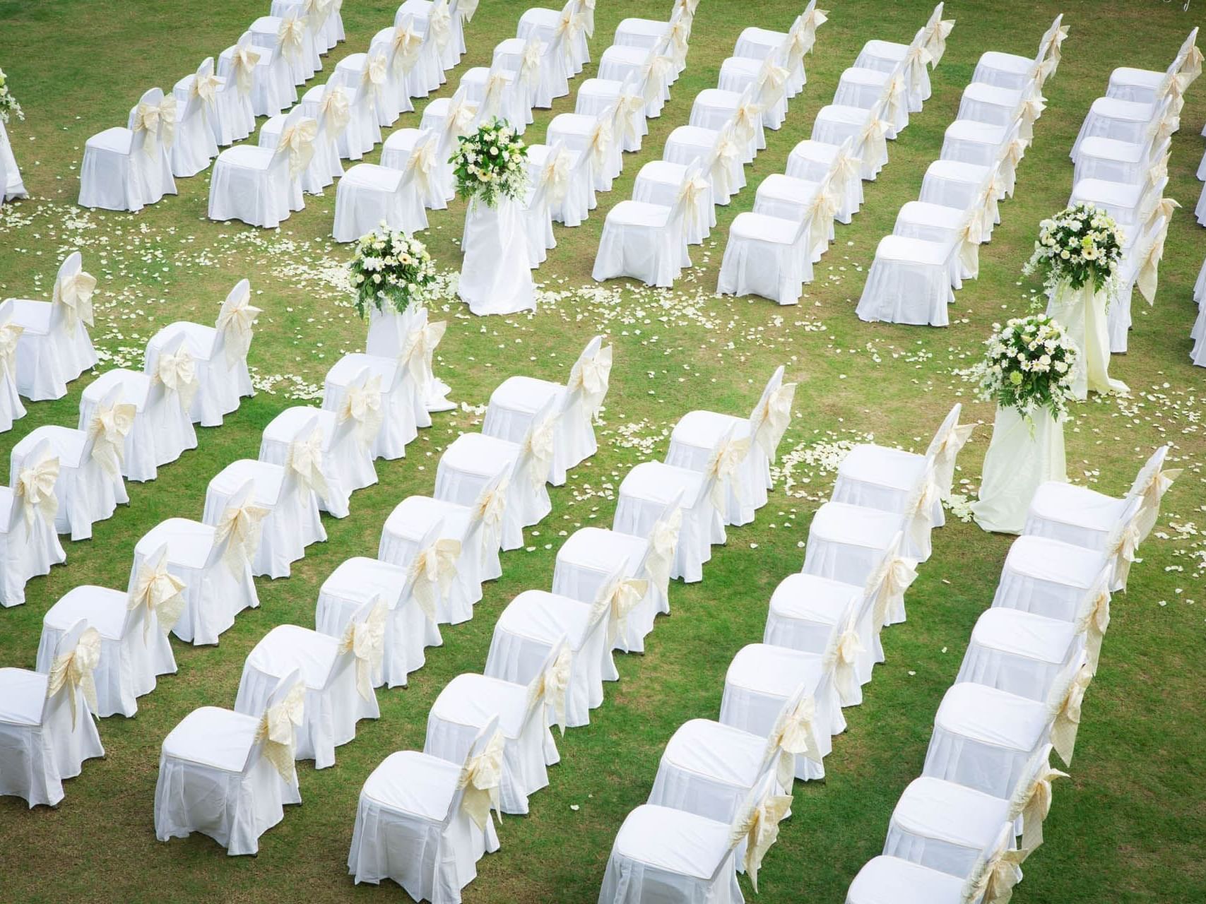 Chairs arranged outdoors for a Wedding ceremony with flowers and decor at Saujana Hotel Kuala Lumpur