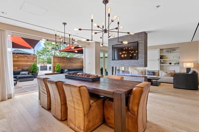 Ambassador Suite with a long wood table by outdoor seating at The J House Greenwich