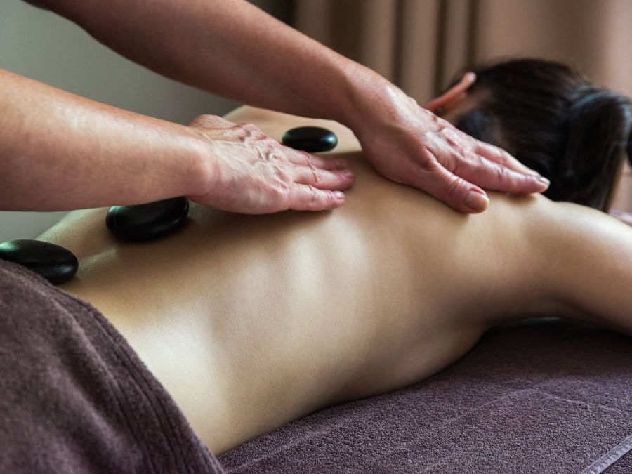 A woman receives a hot stone massage at Villa Borghese