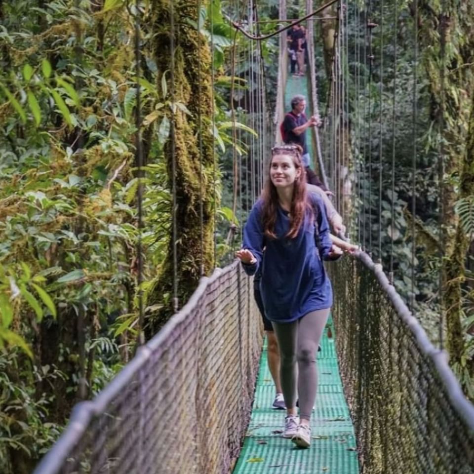 People crossing a rope bridge near Hideaway Rio Celeste