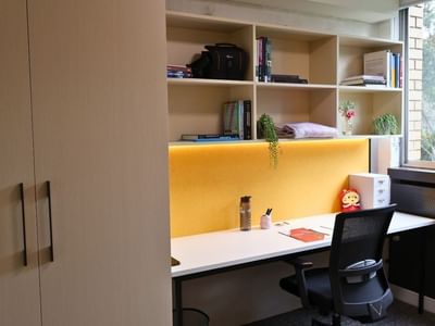 Cozy study nook with desk, chair, and bookshelf at La Trobe University.