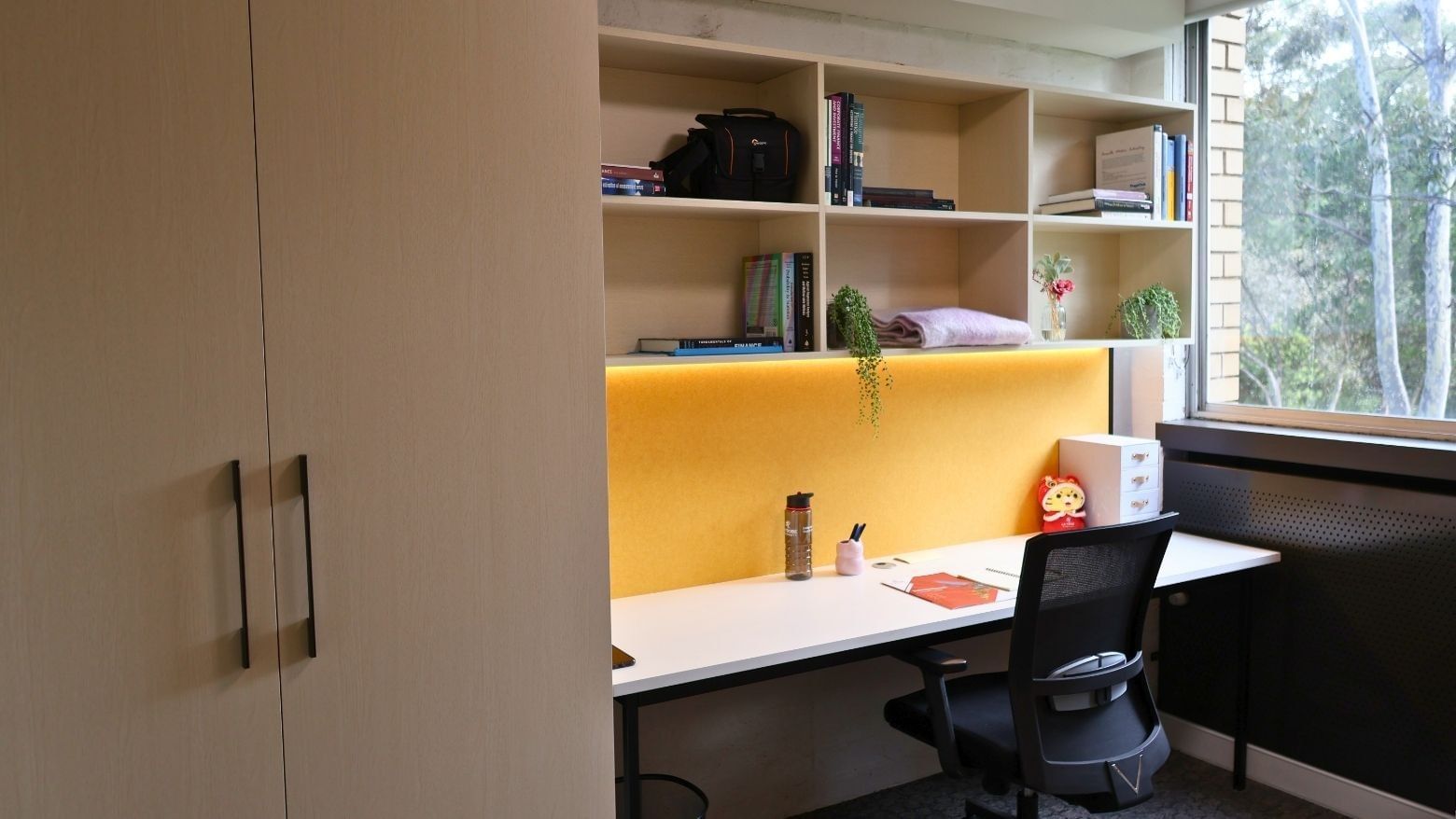 Cozy study nook with desk, chair, and bookshelf at La Trobe University.