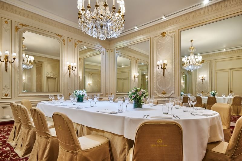 Elegant dining table with lavish chandelier and mirrored walls in Capucines at Hôtel Westminster - Paris