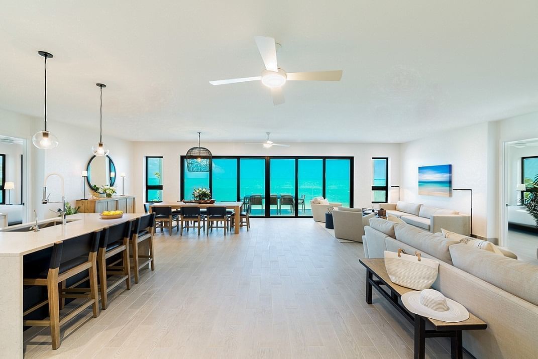 Open-plan Penthouse living and dining area with floor-to-ceiling ocean-view windows at H2O life.style.resort., Long Bay Beach