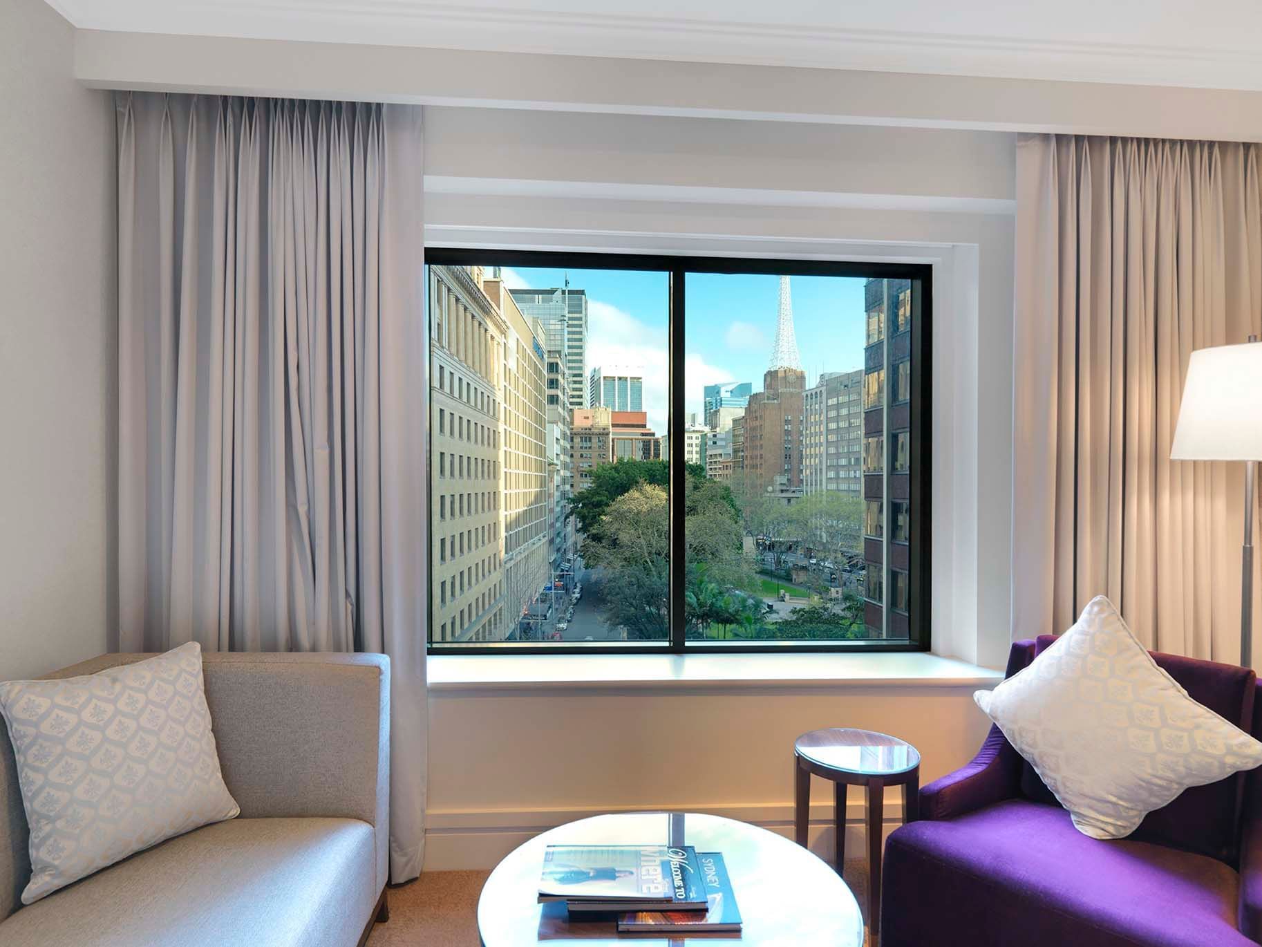 Sofa by window in Duluxe Park Suite at Amora Hotel Sydney