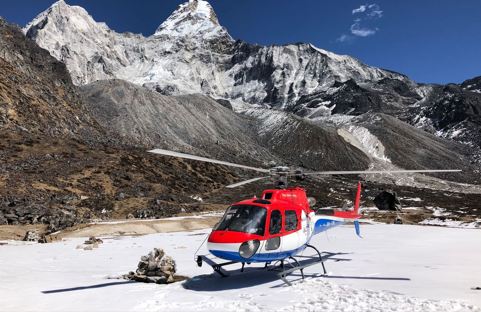Helicopter landing on a snowy mountain near The Terraces Resort & Spa
