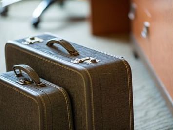 Two suitcases near a room at Paramount Hotel Portland